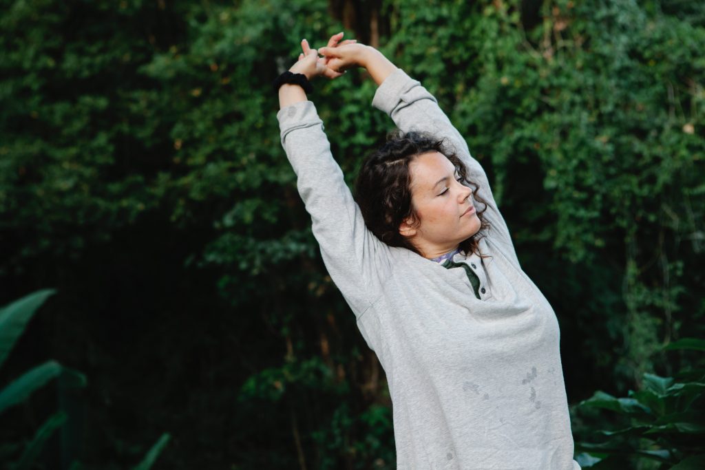 Woman reflecting and stretching