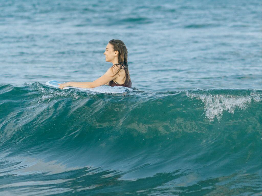 A girl surfing in the Indian Ocean